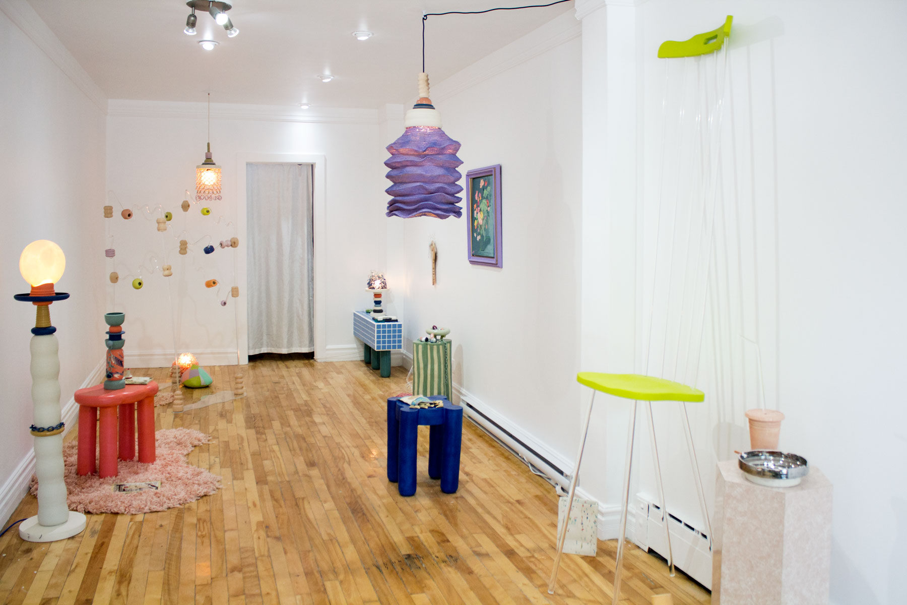 Wide shot of art gallery with multicolored sculptures all over